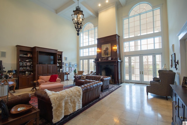 living room with french doors, an inviting chandelier, light tile floors, and a high ceiling