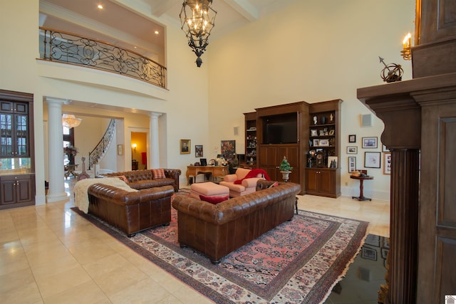 living room with light tile floors, a chandelier, and ornate columns