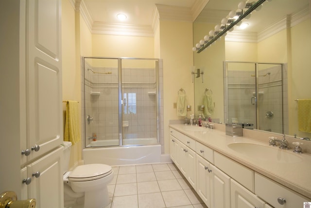 full bathroom with tile flooring, double sink, large vanity, bath / shower combo with glass door, and toilet