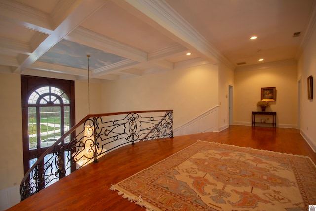 hallway with coffered ceiling, beamed ceiling, ornamental molding, and dark hardwood / wood-style flooring