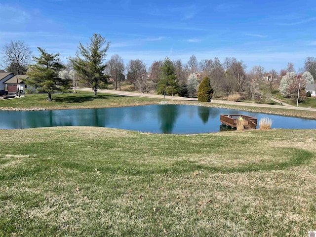 exterior space with a water view and a yard