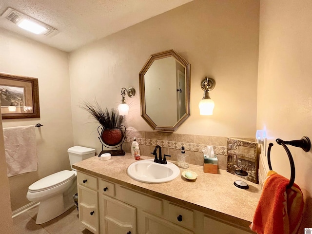 bathroom featuring toilet, tile flooring, tasteful backsplash, a textured ceiling, and vanity