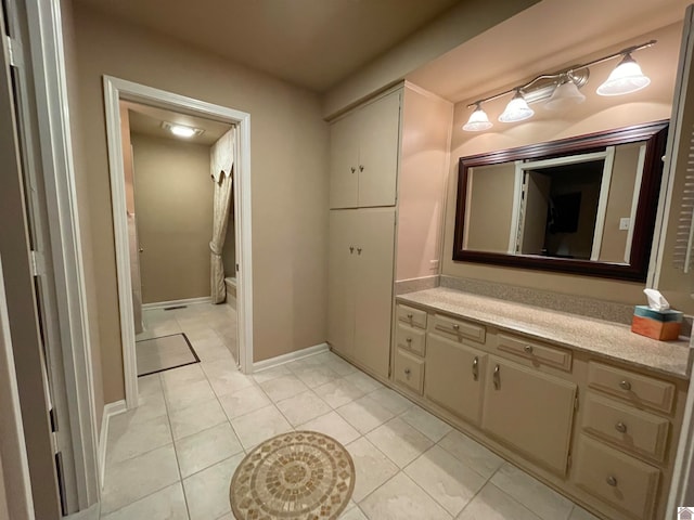 bathroom featuring tile flooring and vanity