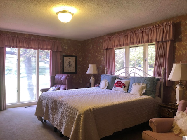 carpeted bedroom with a textured ceiling