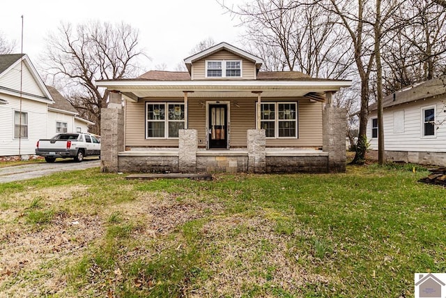 bungalow-style home with a front lawn and a porch