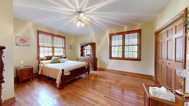 bedroom with a closet, ceiling fan, and hardwood / wood-style flooring