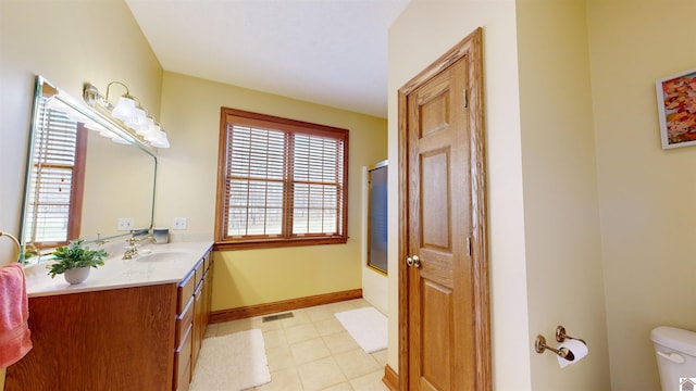 bathroom with tile floors, large vanity, and toilet