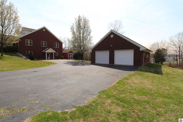 exterior space featuring a front lawn and a garage