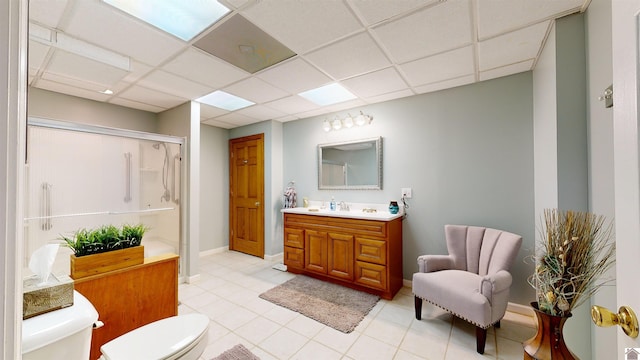 bathroom featuring a paneled ceiling, toilet, tile floors, and oversized vanity