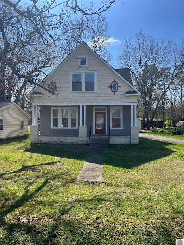 bungalow-style home with a front lawn