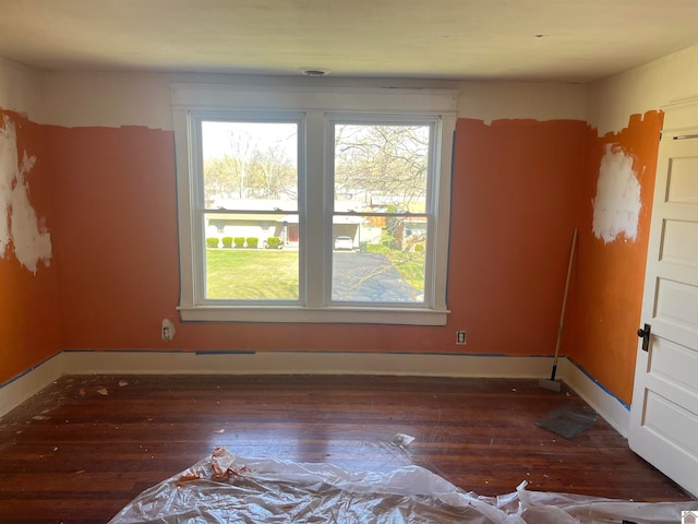 unfurnished room featuring dark hardwood / wood-style floors