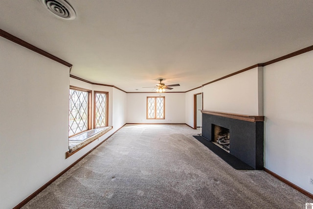 unfurnished living room featuring crown molding, ceiling fan, and carpet