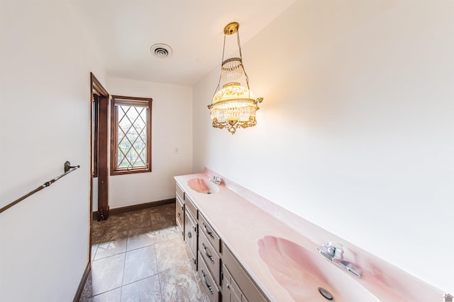 bathroom featuring tile floors and dual bowl vanity