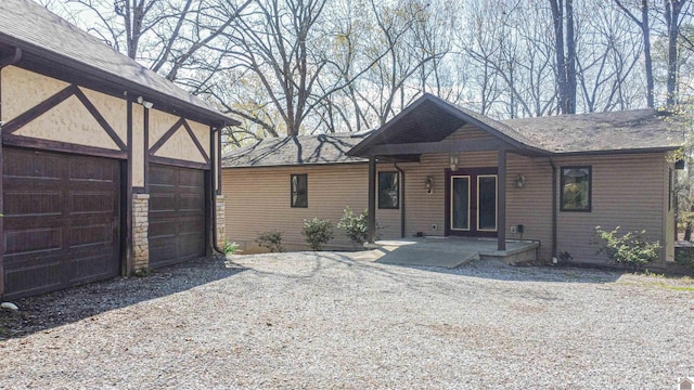 view of front of property with a patio and a garage