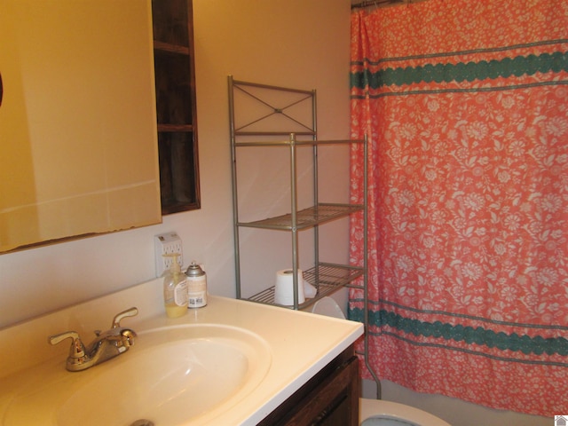 bathroom featuring toilet and vanity