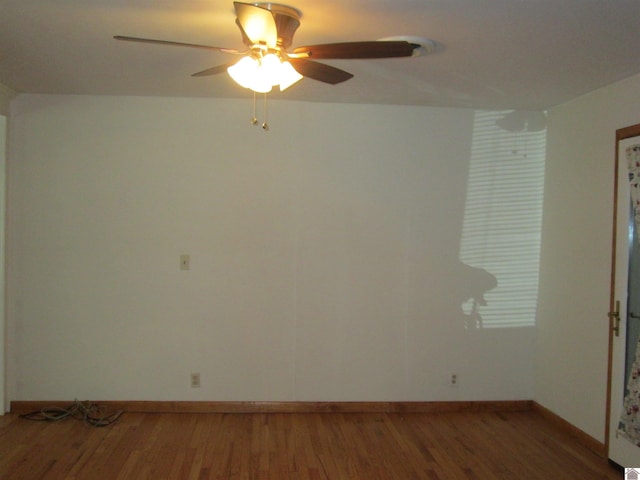 empty room featuring ceiling fan and dark hardwood / wood-style floors