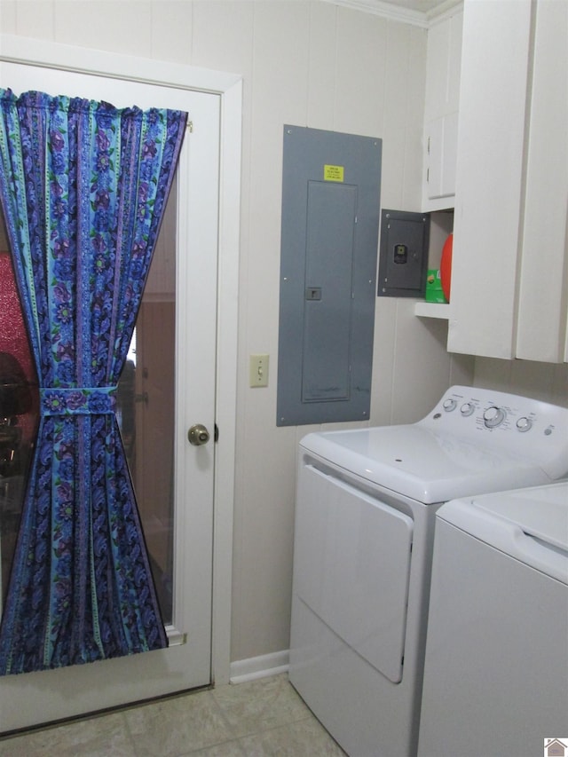 laundry room with washer and clothes dryer, light tile flooring, and cabinets