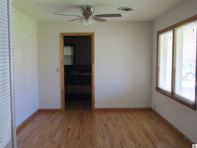 empty room featuring ceiling fan and light hardwood / wood-style floors