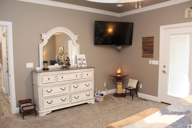 sitting room featuring ornamental molding and light colored carpet