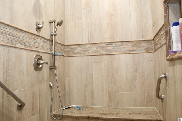 bathroom with tiled shower