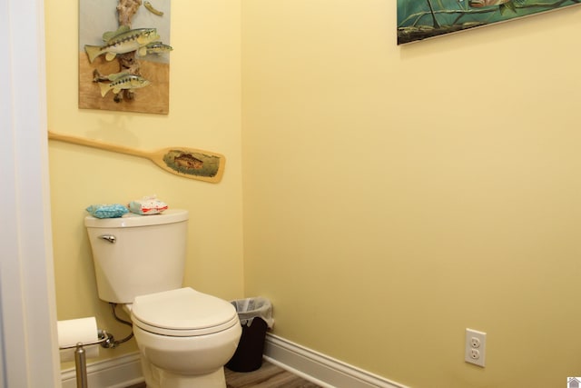 bathroom with hardwood / wood-style flooring and toilet