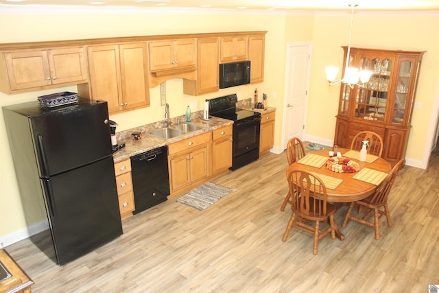 kitchen featuring crown molding, light hardwood / wood-style floors, black appliances, and sink