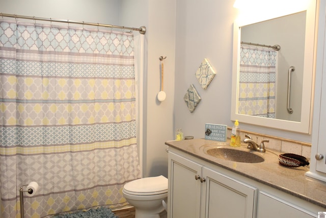 bathroom featuring oversized vanity and toilet