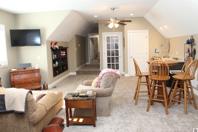 living room featuring ceiling fan, light colored carpet, and vaulted ceiling