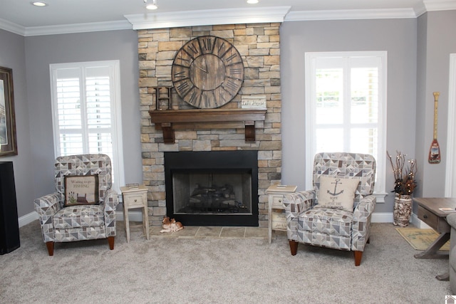 living room featuring a stone fireplace, a healthy amount of sunlight, and ornamental molding