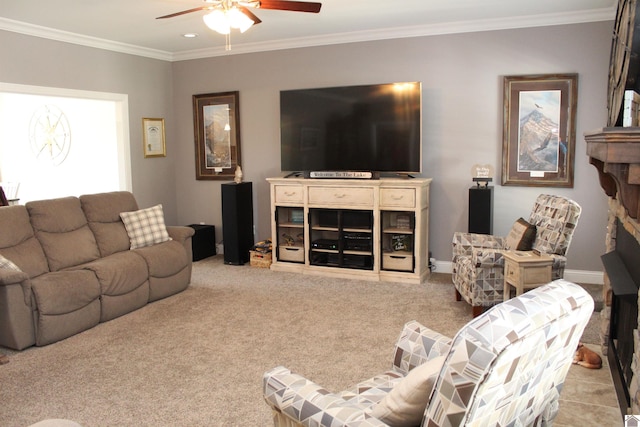 carpeted living room with ceiling fan, ornamental molding, and a fireplace