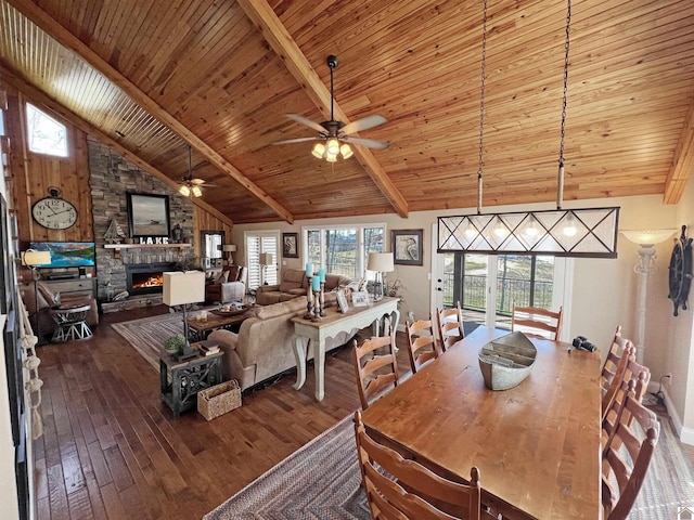 dining space featuring dark hardwood / wood-style flooring, beam ceiling, and a healthy amount of sunlight