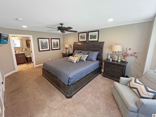 carpeted bedroom featuring ceiling fan and ensuite bath