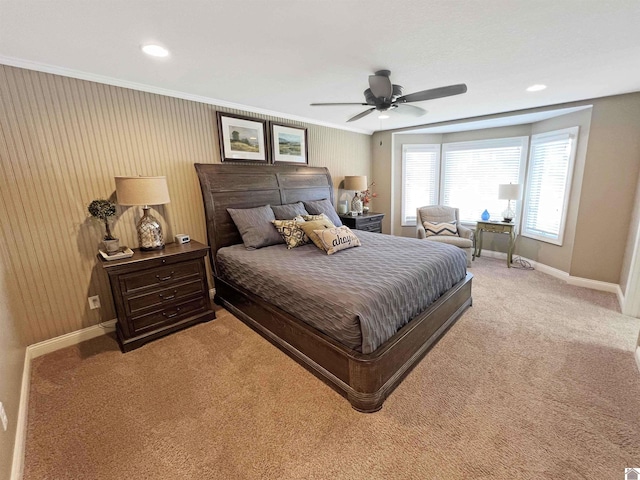 bedroom featuring ceiling fan, ornamental molding, and light colored carpet