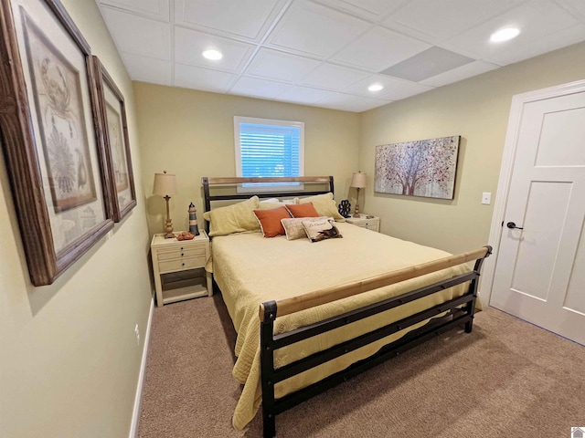 bedroom featuring a paneled ceiling and carpet