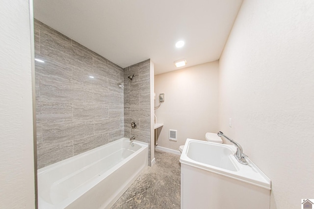 bathroom featuring tile flooring and tiled shower / bath