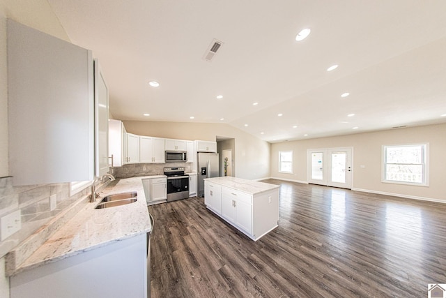 kitchen featuring a healthy amount of sunlight, dark hardwood / wood-style floors, sink, and tasteful backsplash