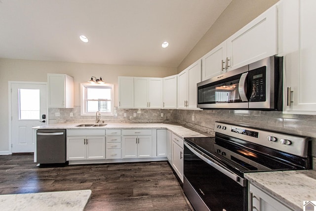 kitchen featuring sink, tasteful backsplash, white cabinetry, and stainless steel appliances