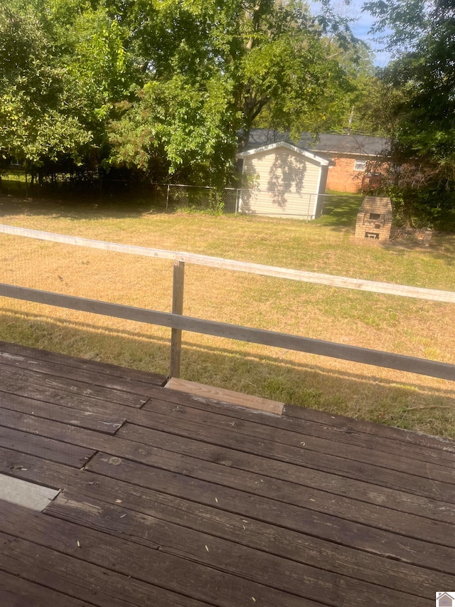 wooden deck featuring a yard