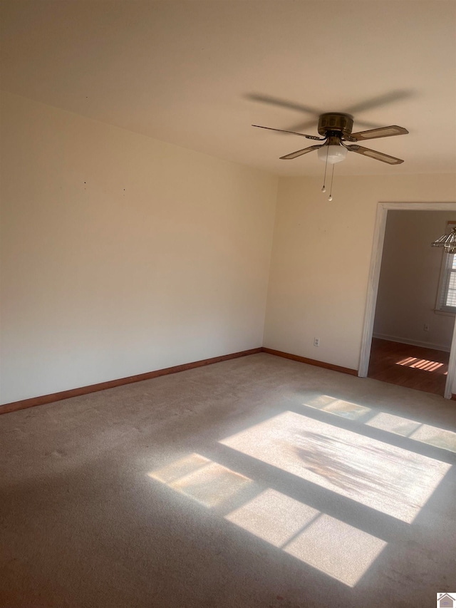 carpeted empty room with ceiling fan