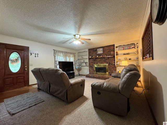 living room with carpet, a fireplace, brick wall, ceiling fan, and a textured ceiling