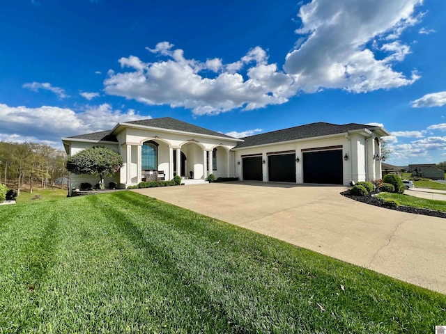 view of front facade with a garage and a front lawn