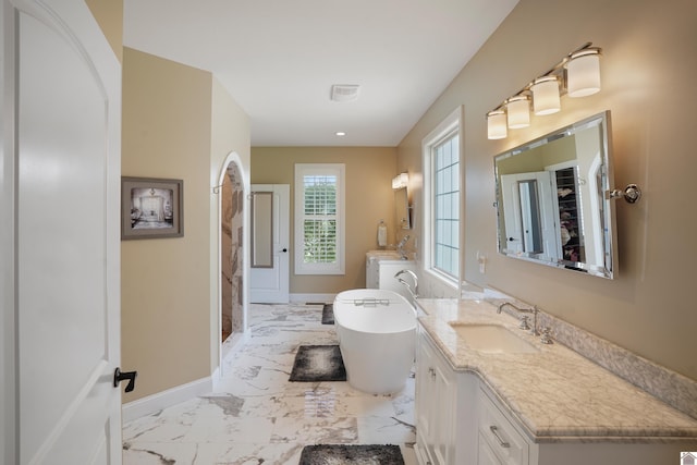 bathroom with independent shower and bath, vanity with extensive cabinet space, and tile floors