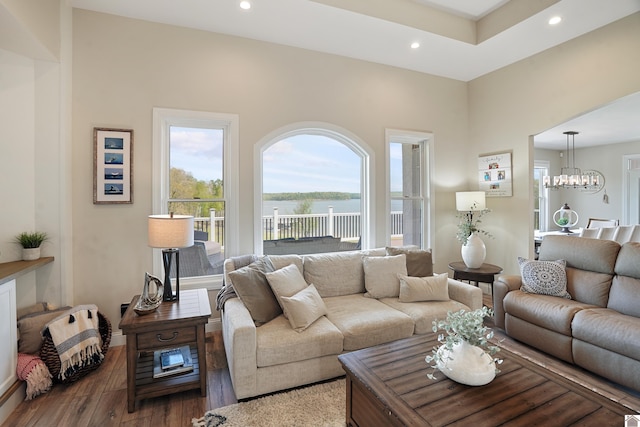 living room featuring dark hardwood / wood-style floors and a chandelier