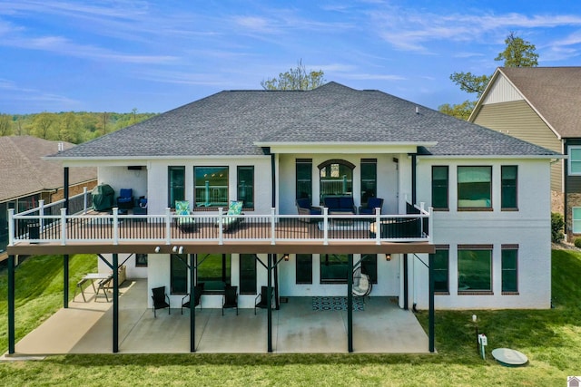 rear view of property featuring a patio area, outdoor lounge area, a wooden deck, and a lawn