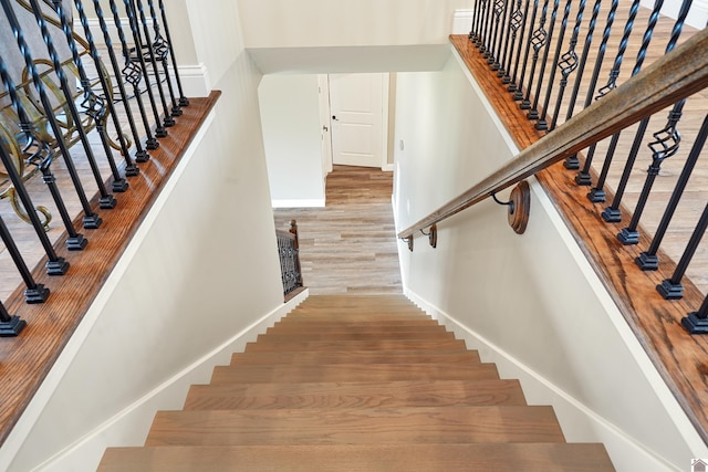 stairway featuring light hardwood / wood-style flooring