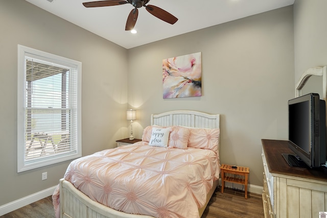 bedroom with ceiling fan and dark hardwood / wood-style floors