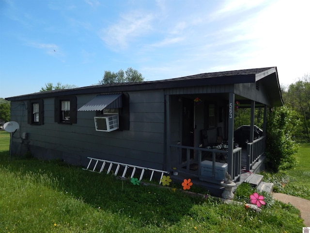 view of side of property with a yard