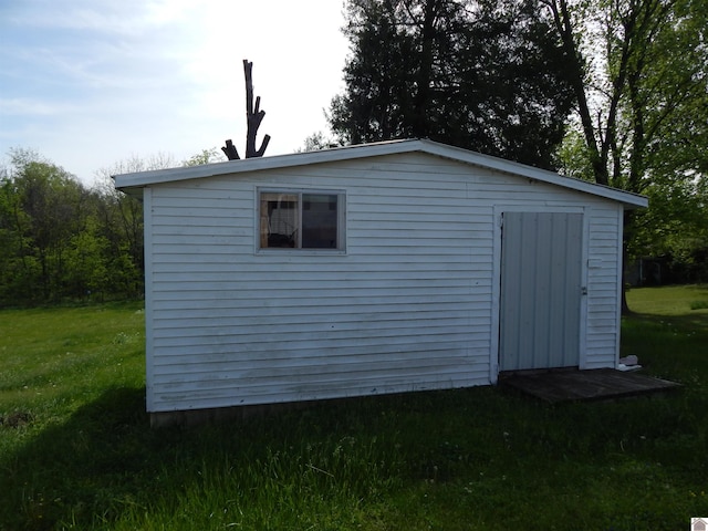 view of outdoor structure featuring a lawn