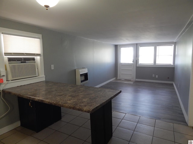 kitchen featuring a kitchen breakfast bar, tile floors, and kitchen peninsula