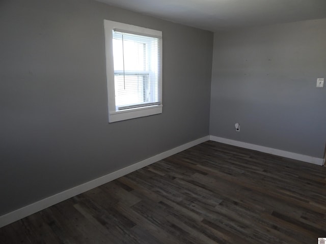 unfurnished room with dark hardwood / wood-style floors